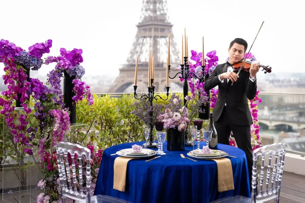 Luxury private dinner proposal at Shangri-La Paris with Eiffel Tower view, royal blue linens, live musician, Dom Perignon champagne, and Saint Louis crystal