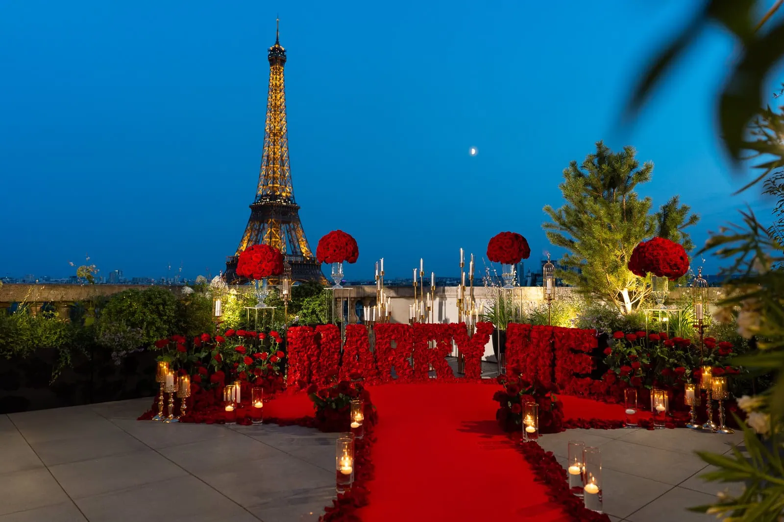 Luxurious "Marry Me" proposal on Shangri-La Paris rooftop. Red carpet, thousands of red roses, and Eiffel Tower view.