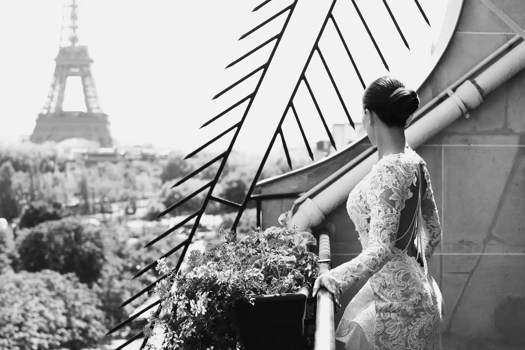 Bride in a Berta couture gown on a private Eiffel Tower terrace at the Plaza Athénée, Paris, during a luxury wedding planned by Kiss Me in Paris.