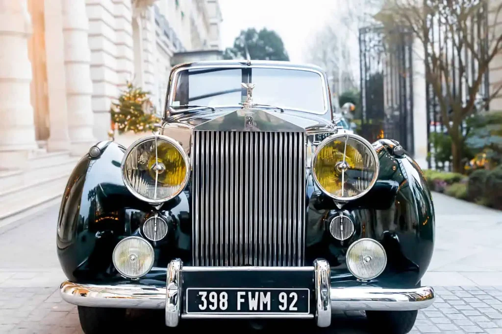 A luxury vintage Rolls-Royce awaits an engaged couple at the prestigious Shangri-La Paris hotel, ready to chauffeur newlyweds through Paris for a romantic champagne tour. Add this timeless transportation option to your Paris proposal photography package for an unforgettable experience